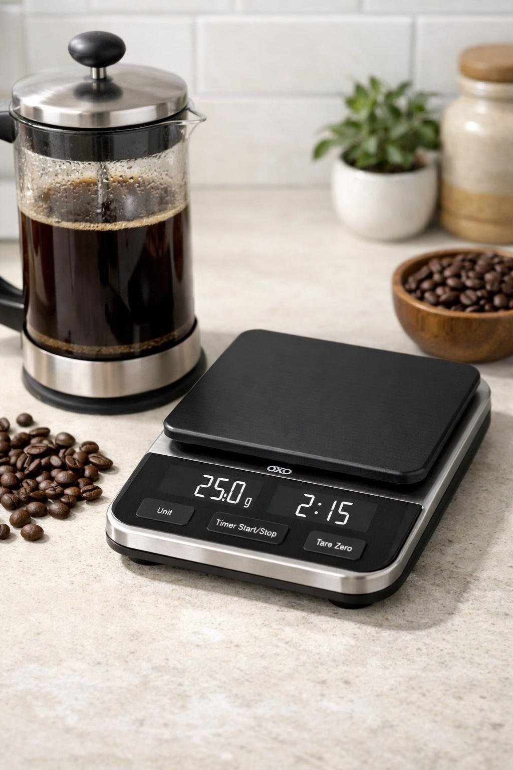 OXO Good Grips Brew Precision Scale beside a French press and coffee beans on a kitchen counter